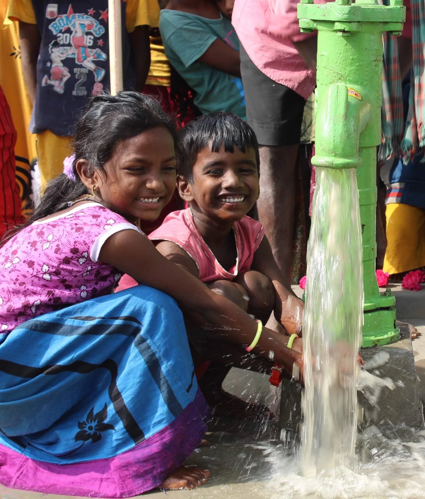Children with clean water from a DonateAWell.org well